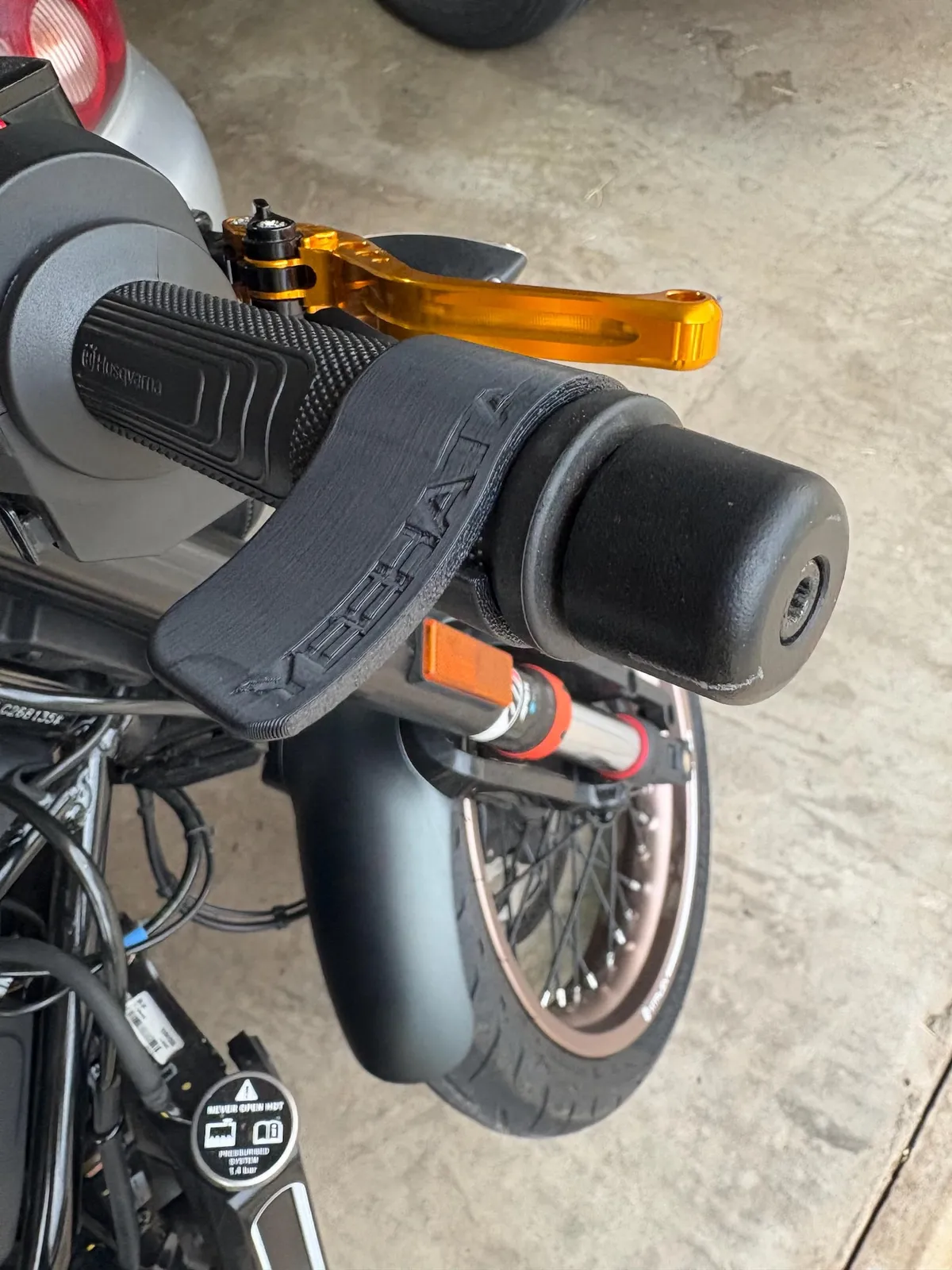 Motorcycle Throttle Palm Rest Mk.1 installed on a handlebar